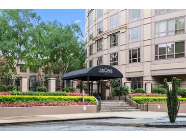 Elegant building entrance with manicured landscaping and a covered entryway, enhancing the property's curb appeal at 3475 Oak Valley Rd # 1850, Atlanta, GA 30326