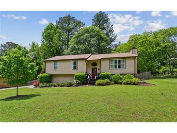 Charming single-Gathering home with a well-manicured lawn, mature trees, and tasteful landscaping at 4192 Alaina Cir, Austell, GA 30106