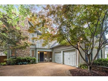 Charming two-story home featuring a stone chimney, inviting entryway, and two-car garage at 626 Kimberly Ne Ln, Atlanta, GA 30306