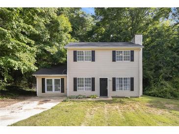 Charming two-story home with black shutters and a welcoming front yard surrounded by lush trees at 430 Pilgrim Ln, Powder Springs, GA 30127