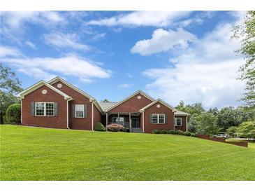 Inviting brick home with a well-manicured lawn and charming curb appeal at 516 Main St, Hiram, GA 30141
