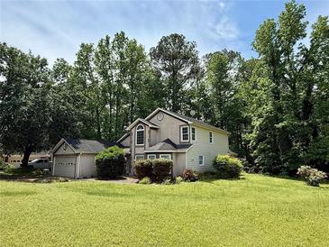 Charming two-story home with well-maintained lawn and mature trees offering a serene and private setting at 1464 Yorktown Nw Dr, Lawrenceville, GA 30043