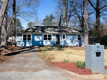 Charming one-story home with a manicured lawn and a brick mailbox at 551 Floyd Se Dr, Smyrna, GA 30082