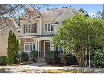 Charming two-story home featuring a stone facade, manicured landscaping, and classic architectural details at 1967 Mason Mill Rd, Decatur, GA 30033