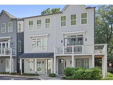 Charming three-story townhome with balcony and neutral gray paint at 3 Becker Nw Pl, Atlanta, GA 30307
