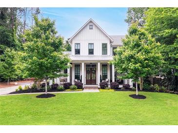Charming, two-story traditional home with a manicured lawn and a welcoming front porch at 201 Dobbs Rd, Woodstock, GA 30188