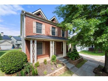 Charming two-story brick home featuring a welcoming front porch, well-maintained landscaping, and inviting curb appeal at 3826 Baxley Village Trl, Suwanee, GA 30024