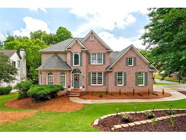 Charming two-story brick home with manicured lawn and mature landscaping at 101 Misty Valley Dr, Canton, GA 30114
