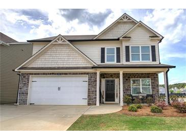 Charming two-story home with stone accents, covered porch, two-car garage, and manicured front yard at 200 Eva Way Ne, Cartersville, GA 30121