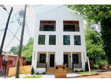Modern two-story home with white brick, black framed windows, and second story balconies at 262 Crumley St Sw, Atlanta, GA 30312