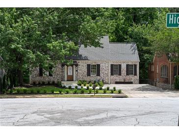 Charming brick home with a well-maintained front yard, lovely landscaping, and a classic roofline at 833 Martina Ne Dr, Atlanta, GA 30305