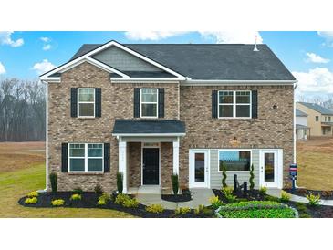Charming two-story home with brick facade, black shutters, and well-manicured landscaping at 1288 Hollingsworth Way, Dacula, GA 30019