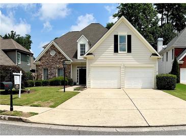 Charming two-story home with a stone facade, manicured lawn, and a two-car garage at 1294 Parkview Nw Ln, Kennesaw, GA 30152