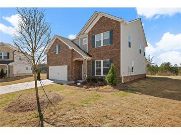 Two-story home showcasing brick and siding with blue shutters and an attached two-car garage at 1246 Allspice Way, Lawrenceville, GA 30045