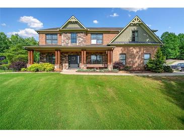 Beautiful brick home with a large front yard and welcoming porch at 501 Rabun Ct, Canton, GA 30115
