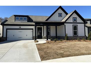 Charming, modern farmhouse-style home with a two-car garage, covered porch and manicured lawn at 214 Saratoga Dr, Acworth, GA 30102