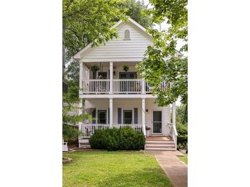 Charming two-story home featuring double front porches with white railings and classic architectural details at 207 Wesley Ne Ave, Atlanta, GA 30307