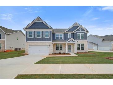 Charming two-story home featuring stone accents, complementary siding, and a well-manicured lawn at 242 Linford Dr, Locust Grove, GA 30248