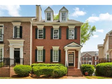 Charming brick townhome with well-maintained landscaping, black shutters, and a welcoming entrance at 4676 Ivygate Se Cir, Atlanta, GA 30339
