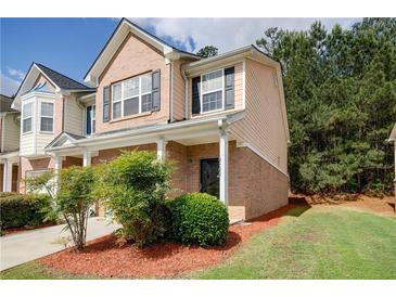 Charming two-story townhome with brick accents, manicured landscaping, and a welcoming front porch at 4844 W Park Cir # 4844, College Park, GA 30349
