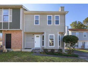 Charming two-story home with light grey siding, white trim, and a well-manicured front yard at 107 Woodberry Ct, Woodstock, GA 30188