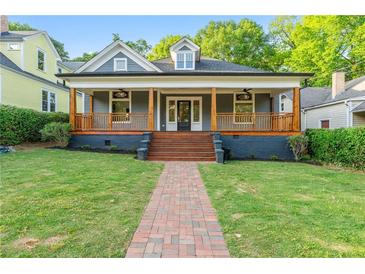 Charming home featuring a covered porch with wooden details and a brick pathway leading to the entrance at 378 Grant Park Pl, Atlanta, GA 30315