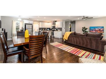 Open concept living room featuring hardwood floors, dining area, updated kitchen, and comfortable seating at 3224 Canary Ct, Decatur, GA 30032