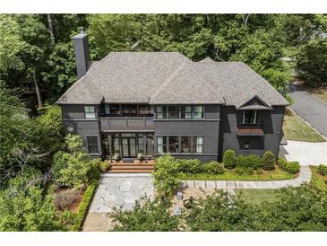 Stately two-story home with a manicured front yard and gray exterior, surrounded by mature trees at 320 Shady Grove Ln, Alpharetta, GA 30009