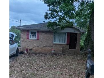 Charming brick home with red shutters and a covered front porch at 735 S Grand Nw Ave, Atlanta, GA 30318