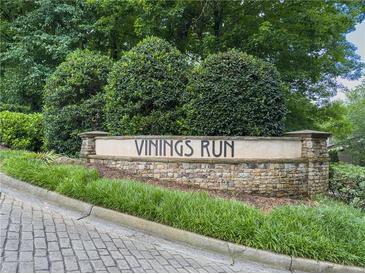 Stone entrance sign to Vinings Run community surrounded by manicured landscaping and mature trees at 2610 Cumberland Ct, Smyrna, GA 30080