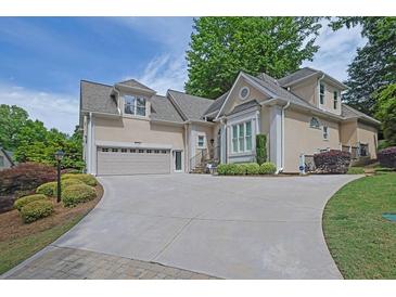 Stately two-story home featuring manicured landscaping and a spacious driveway at 4566 Fountain Ne Dr, Marietta, GA 30067