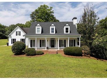 Charming single-Gathering home featuring a large front porch and manicured lawn at 255 Henson Way, Canton, GA 30115