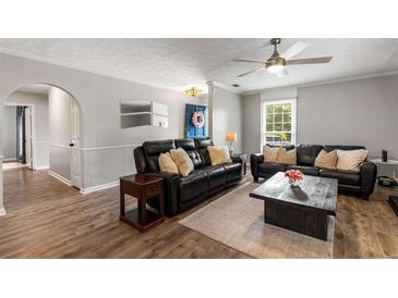 Comfortable living room features wood floors, ceiling fan and leather sofas for a relaxing space at 1140 Moorestown Cir, Decatur, GA 30033