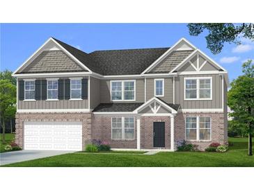 Charming two-story home with a brick facade, well-manicured lawn and integrated two-car garage at 612 Sidney Ct, Stockbridge, GA 30281