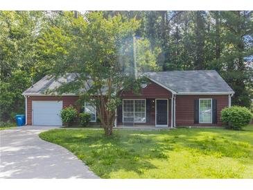 Charming one-story home featuring a well-manicured lawn, attached garage, and classic design at 340 Onyx Ct, Atlanta, GA 30349