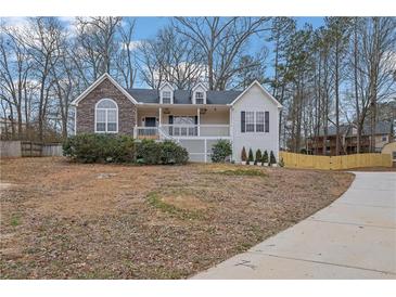 Charming home with stone accents, a cozy front porch, and manicured landscaping at 954 Josie Ct, Lawrenceville, GA 30045
