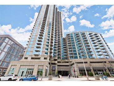 Modern high-rise condo building with balconies and street-level shops, parking garage and beautiful landscaping at 400 W Peachtree Nw St # 3611, Atlanta, GA 30308