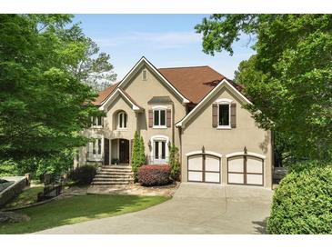 Stunning two-story home with a well-manicured lawn and attached two-car garage at 95 Grogans Lndg, Atlanta, GA 30350