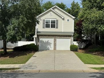 Charming two-story home featuring a two-car garage and well-maintained landscaping at 143 Ilex Dr, Canton, GA 30114