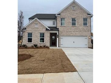 Charming two-story home showcasing a brick facade, a two-car garage, and a well manicured lawn at 1781 Jordan Brook Dr, Lawrenceville, GA 30043