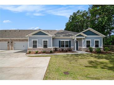 Charming single-story home featuring a well-manicured lawn and an attached two-car garage at 3919 Shelleydale Dr, Powder Springs, GA 30127