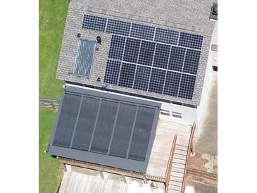 Aerial view of a home featuring multiple solar panels on the roof and over the patio at 3112 Calumet Nw Cir, Kennesaw, GA 30152