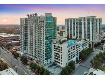 Luxury high-rise condominiums with an outdoor rooftop pool overlooking the city skyline at sunset at 250 Pharr Ne Rd # 1112, Atlanta, GA 30305