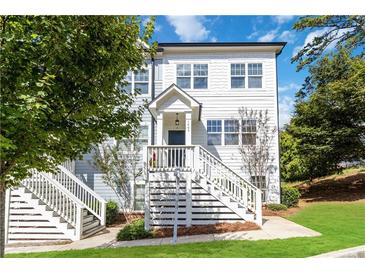 Charming two-story townhome with a welcoming front porch and well-maintained landscaping at 1405 Attwater Dr, Atlanta, GA 30316