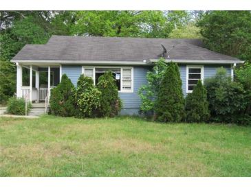 Traditional single story home with blue siding, lush landscaping, and a covered front porch at 2172 Jernigan Drive Se, Atlanta, GA 30315