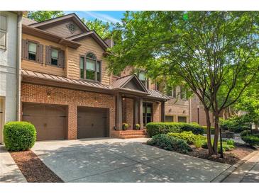 Charming two-story home with brick and siding exterior, attached two-car garage, and professionally landscaped front yard at 2664 Long Pointe, Johns Creek, GA 30076