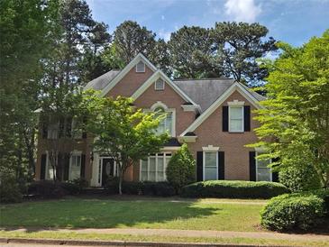 Traditional two-story brick home with black shutters and a well-manicured front lawn at 1000 Admiral Xing, Alpharetta, GA 30005