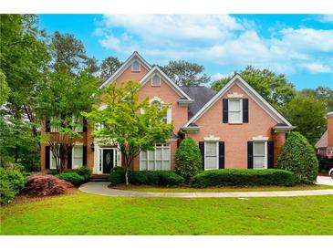 Charming two-story brick home with manicured lawn and mature landscaping at 1000 Admiral Xing, Alpharetta, GA 30005