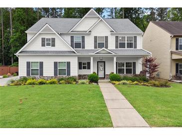 Charming two-story home boasts a well-manicured lawn, welcoming front porch, and classic design details at 336 Parc Xing, Acworth, GA 30102