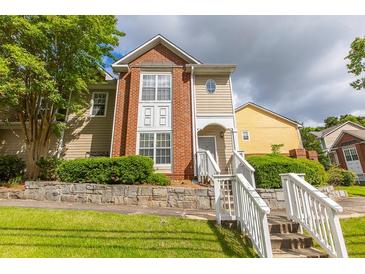 Charming multi-level home featuring a mix of brick and siding with stone retaining wall and landscaped lawn at 1731 Pryor Sw Rd # 109, Atlanta, GA 30315
